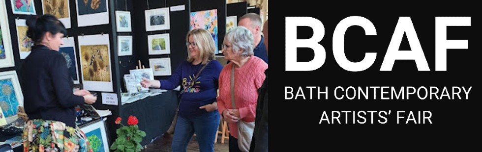 People buying art at Bath Contemporary Art Fair, with the BCAF logo